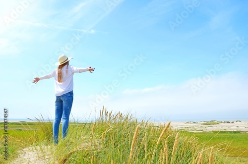 happy woman raising hands  feeling good  north sea island r  m    denmark  