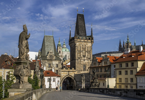 Charles Bridge with its statuette, Lesser Town Bridge Tower and the tower of the Judith Bridge.In the background could see the beautiful Cathedral of St. Nicholas.Prague, Czech Republic.