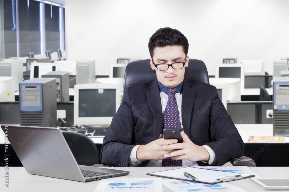 Naklejka premium Worker reading a message in office room