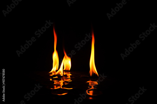 Individual flames of fire with reflection