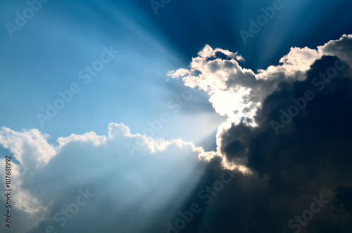 Sunbeam through the black stormy cloud