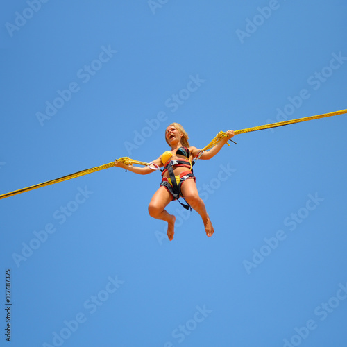 jumping girl on the trampoline at  funfair