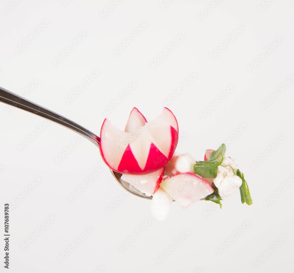 Cottage cheese with radish and chives on a fork