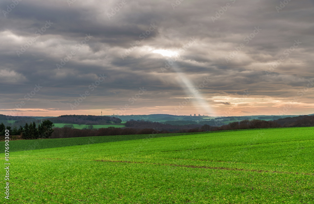 Natural landscape with sunrays and clouds