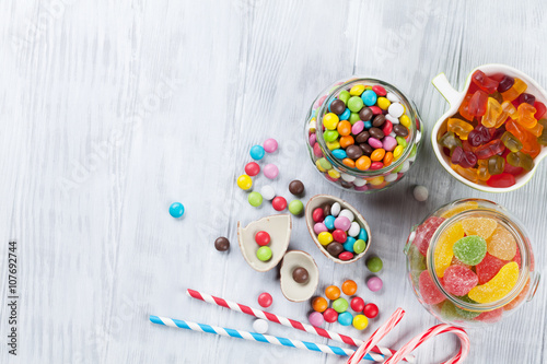 Colorful candies on wooden table