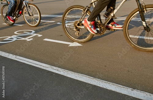 Bicycle road sign and two bike riders