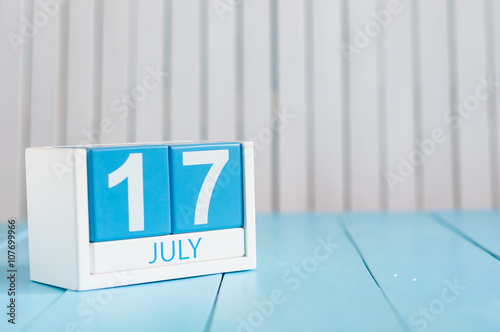 July 17th. Image of july 17 wooden color calendar on white background. Summer day. Empty space for text photo