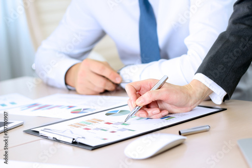 Business colleagues working and analyzing financial figures on a