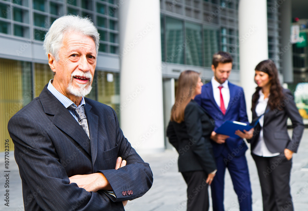 Beautiful man on the background of business people Beautiful man on the background of business people
