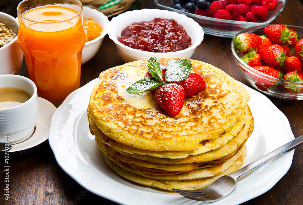stack of freshly prepared traditional pancakes with strawberries stack of freshly prepared traditional pancakes with strawberries