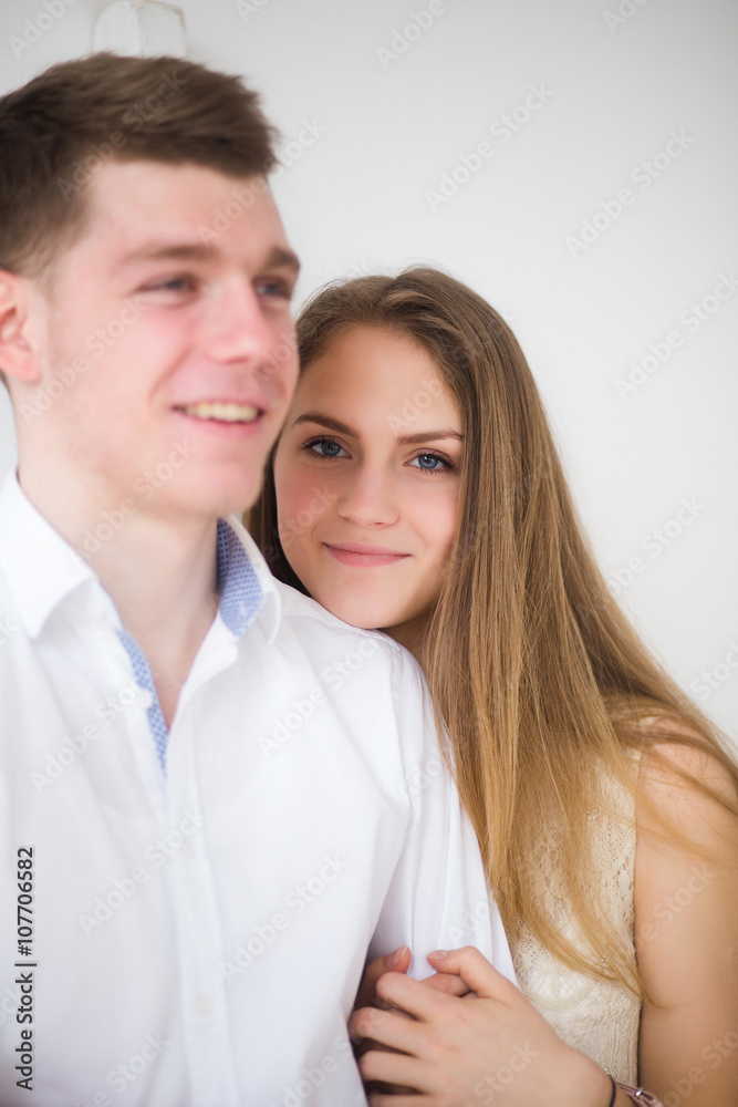 Happy woman dressed in shirt put her head on shoulder of man Happy woman dressed in shirt put her head on shoulder of man