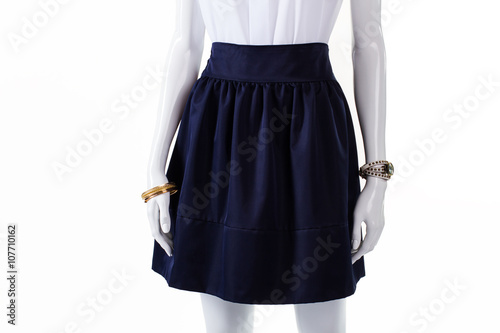 Dark navy skirt on mannequin. Navy skirt and wrist accessories. Navy cotton skirt with folds. Girl's high-quality cotton garment.