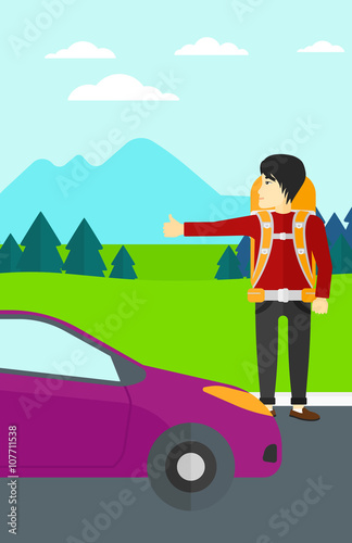 Young man hitchhiking.
