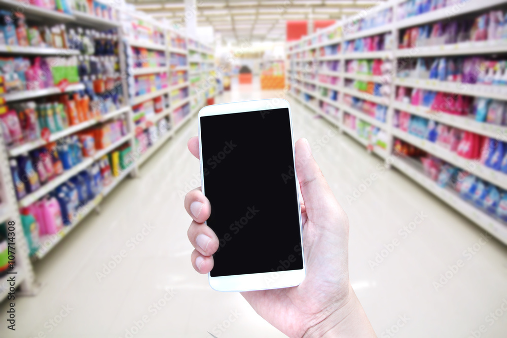hand hold smartphone in supermarket hand hold smartphone in supermarket