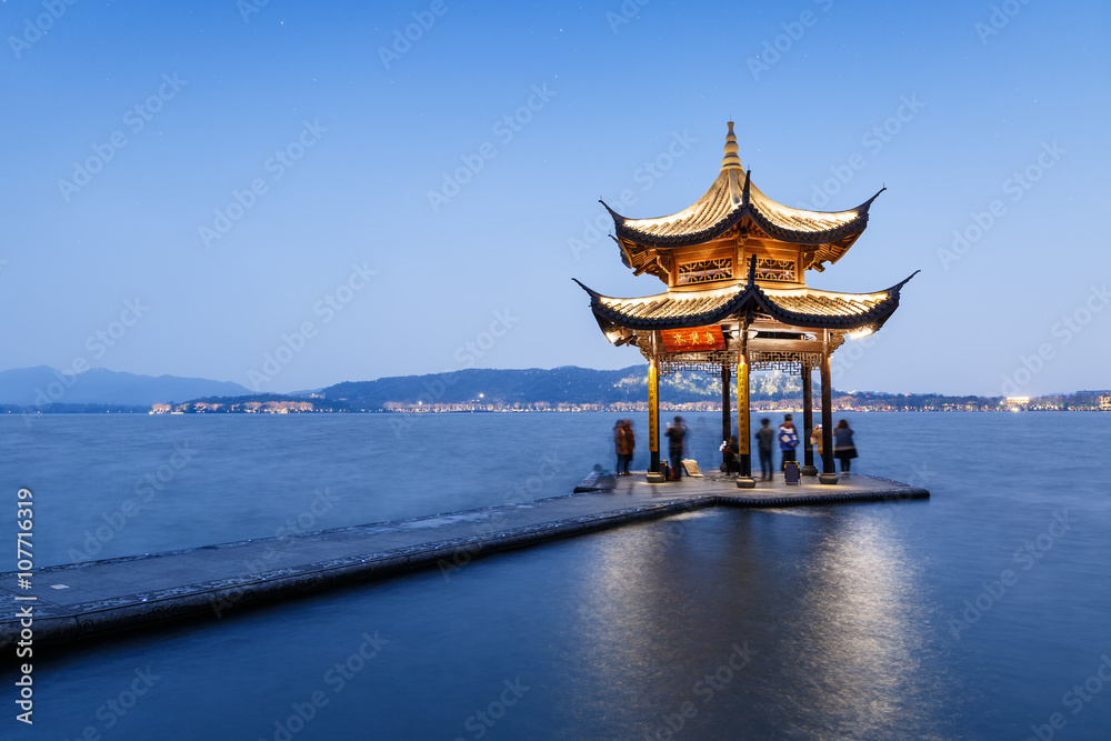 Hangzhou west lake ancient pavilion building at dusk, in China Hangzhou west lake ancient pavilion building at dusk, in China