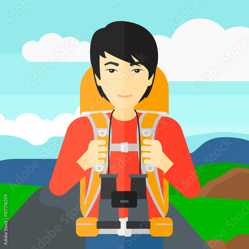 Cheerful backpacker with binoculars.