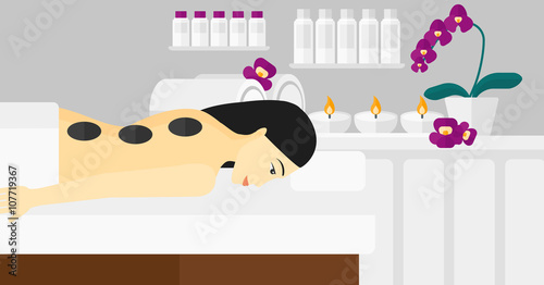 Woman getting stone therapy.