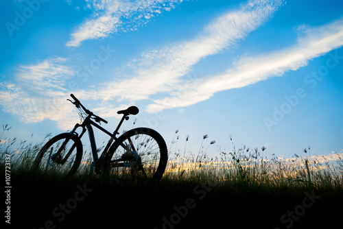 Silhouette Mountain biking, down hill at sunset © anatskwong