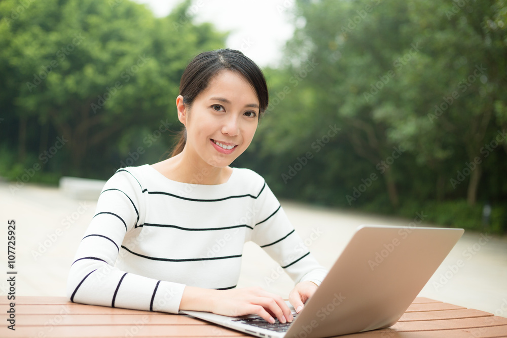 Woman working on notenook computer at outdoor Woman working on notenook computer at outdoor