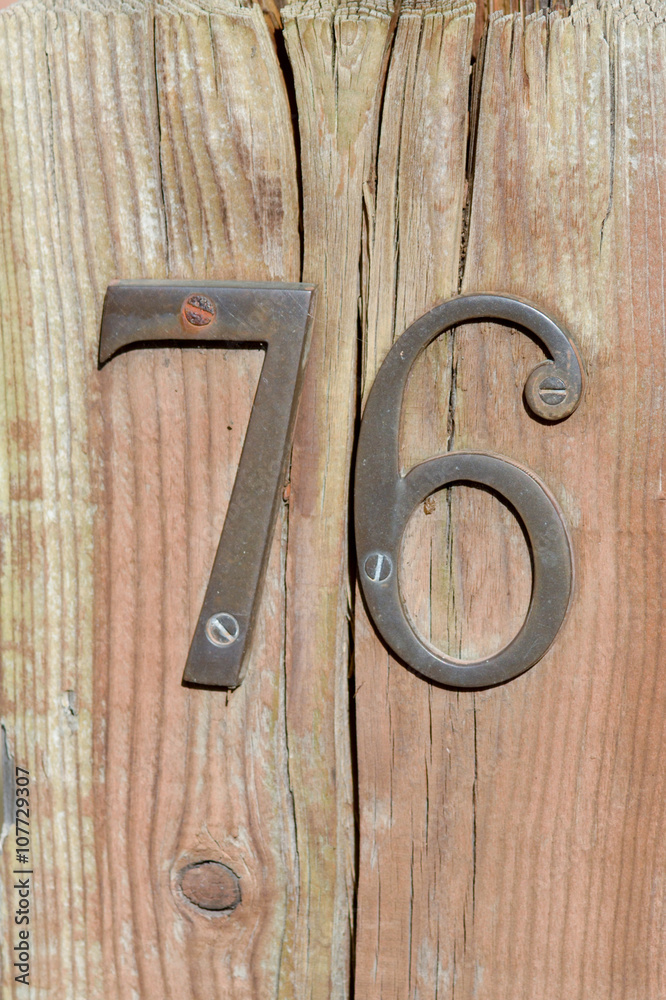 House number 76 sign on gate House number 76 sign on gate