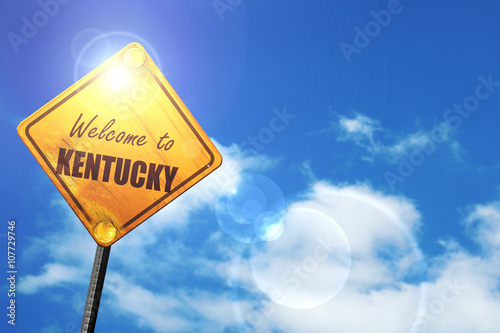 Yellow road sign with a blue sky and white clouds: Welcome to ke photo