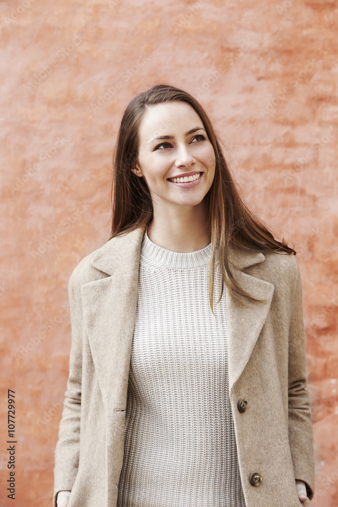 Beautiful young woman in n long coat, smiling Beautiful young woman in n long coat, smiling