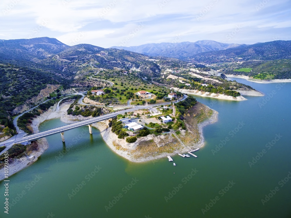 Aerial view of the earthfill dam (aka Embankment Dam) in Yermasoyia,Limassol,Cyprus. The bridge leading to the mountains, the water reservoir, artificial lake and the nature trails in Germasogia area.