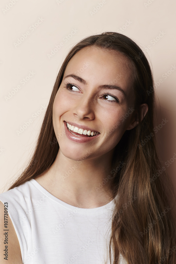 Smiling young model looking away in studio Smiling young model looking away in studio