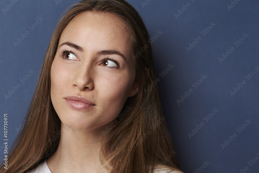Thoughtful young woman in blue studio Thoughtful young woman in blue studio