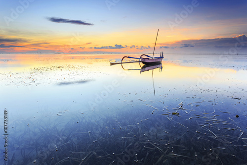 Balinese jukung fishermen with beautiful sunrise in Bali, Indonesia