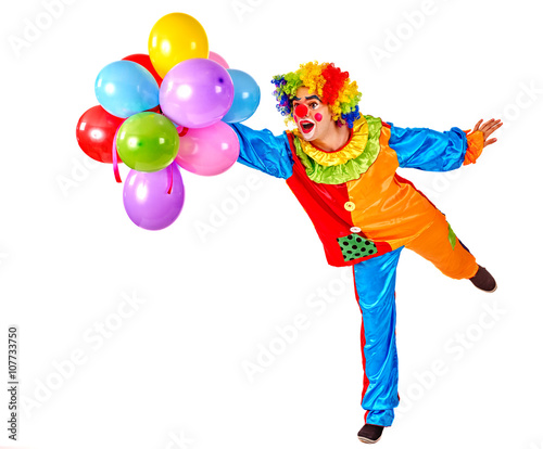 Happy birthday. Glad clown holding a bunch of balloons. Isolated.