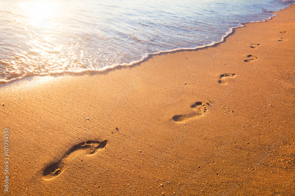 beach, wave and footprints at sunset time beach, wave and footprints at sunset time