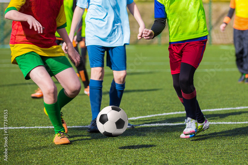 Football soccer game of youth teams. Running young players kicking soccer ball © matimix