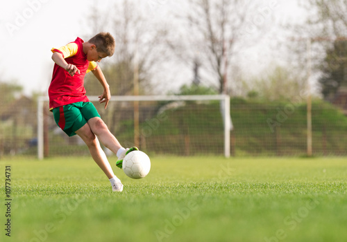 boy kicking a ball at goal © Dusan Kostic