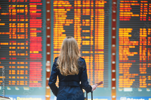 Young female traveler in international airport photo