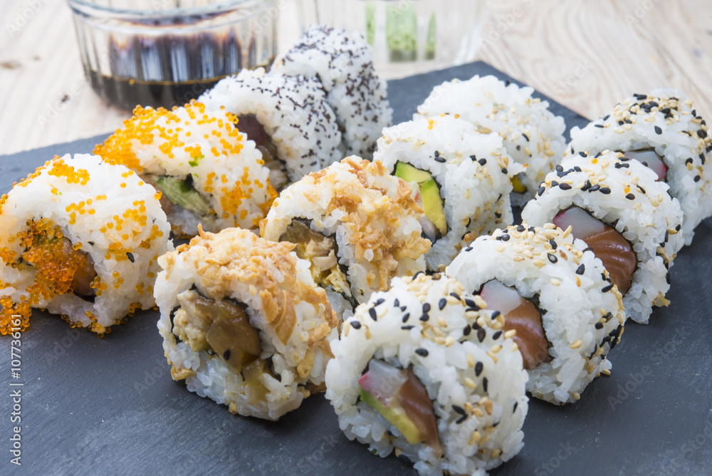 Sushi rolls on a slate plate Sushi rolls on a slate plate