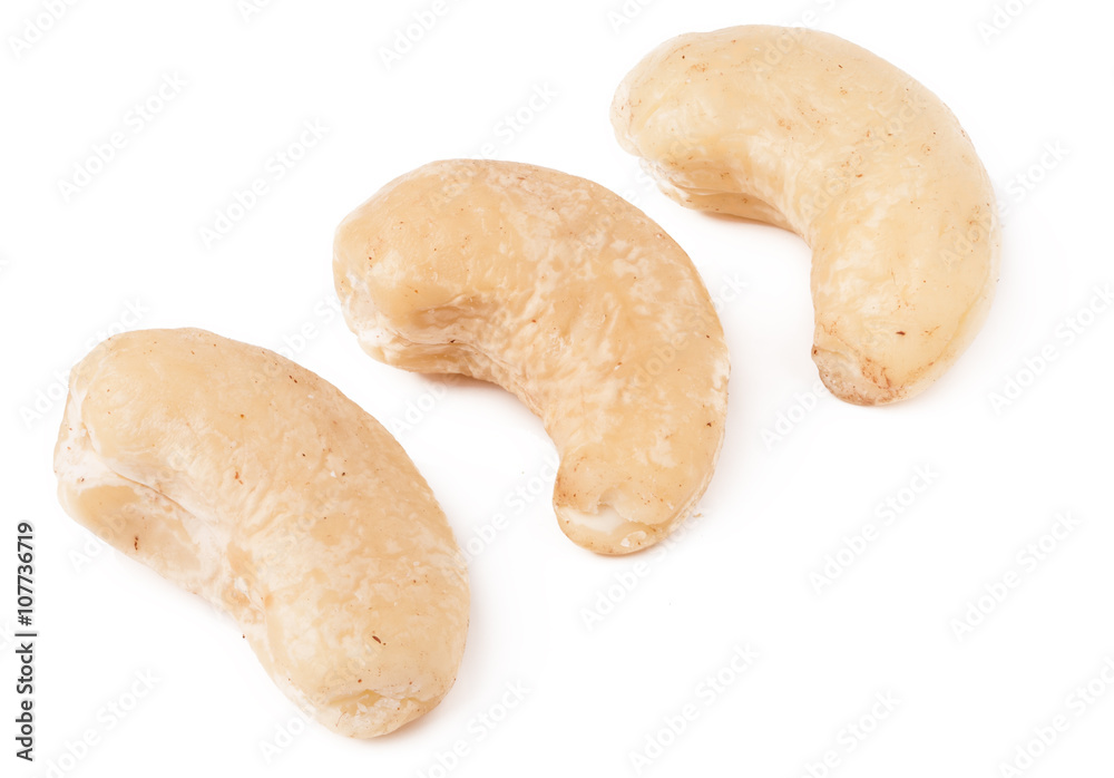few cashew nuts on a white background close-up few cashew nuts on a white background close-up
