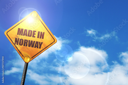 Yellow road sign with a blue sky and white clouds: Made in norwa photo