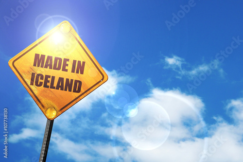 Yellow road sign with a blue sky and white clouds: Made in icela photo