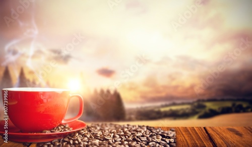 Composite image of orange mug and coffee beans