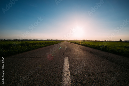 Paved road under the sun