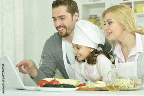 happy family cooking  in kitchen