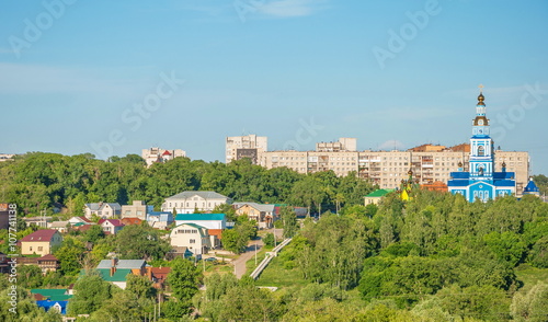 Urban provincial landscape with park, houses and temple