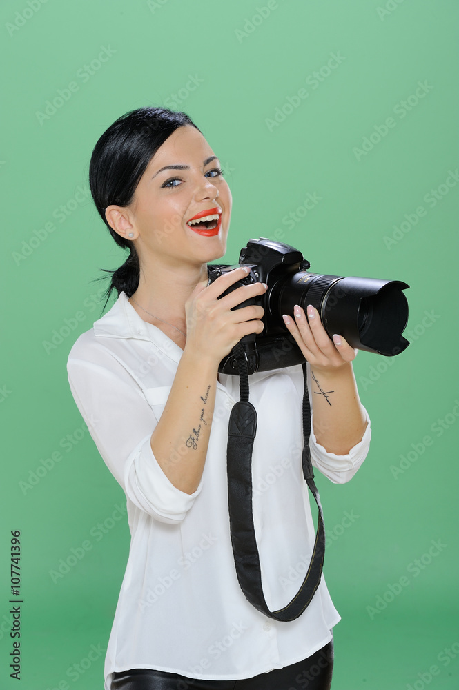 Obraz premium Portrait of a happy young woman holding a digital SLR camera. Vertical shot. Isolated on chroma green background