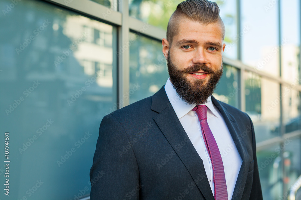 Portrait of a young focused businessman outside the office build Portrait of a young focused businessman outside the office build