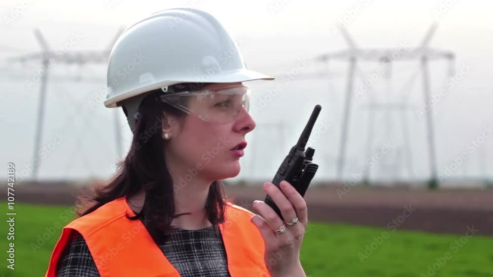 Electrical distribution engineer talking on a walkie- talkie Electrical distribution engineer talking on a walkie- talkie