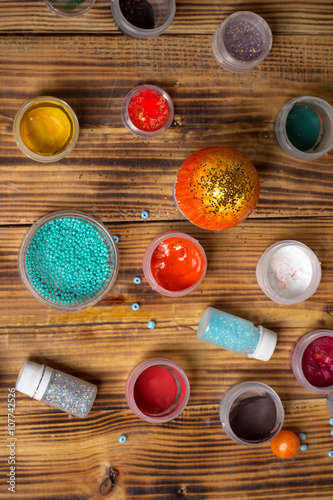 paint cans, glitters, sweets for making easter eggs, food photography