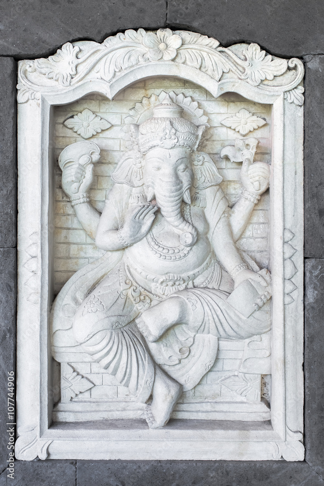 Stone sculpture of Ganesha god on the house wall in Bali