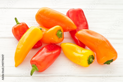 Colorful mini paprika on a white wooden table