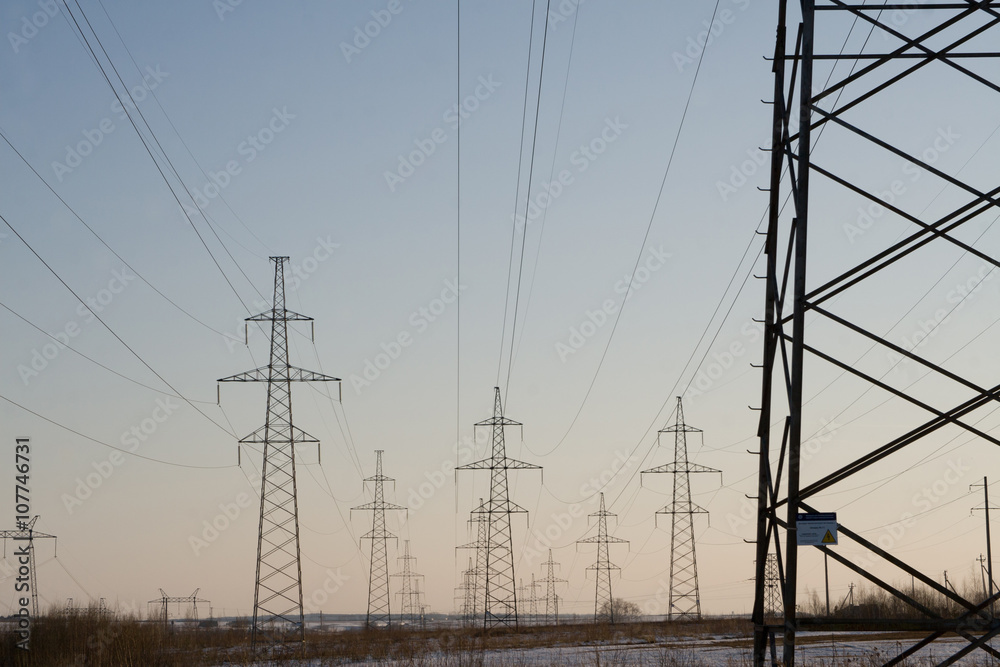Electric power station lines, on the blue sky backing in the sunset Electric power station lines, on the blue sky backing in the sunset